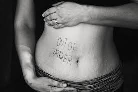 Woman's stomach saying "Out Of Order"