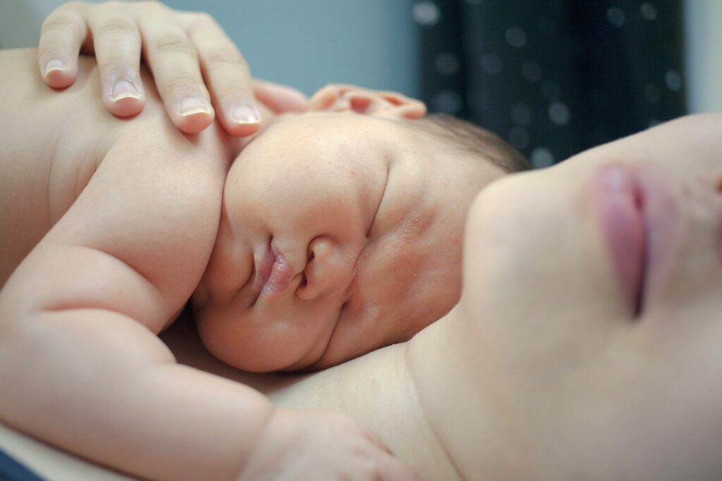 newborn laying on mother's chest