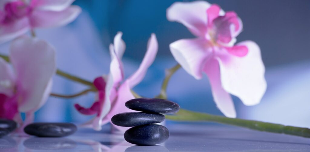 image of massaging stones with orchid flowers