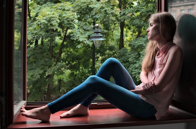 woman thinking while looking out the window