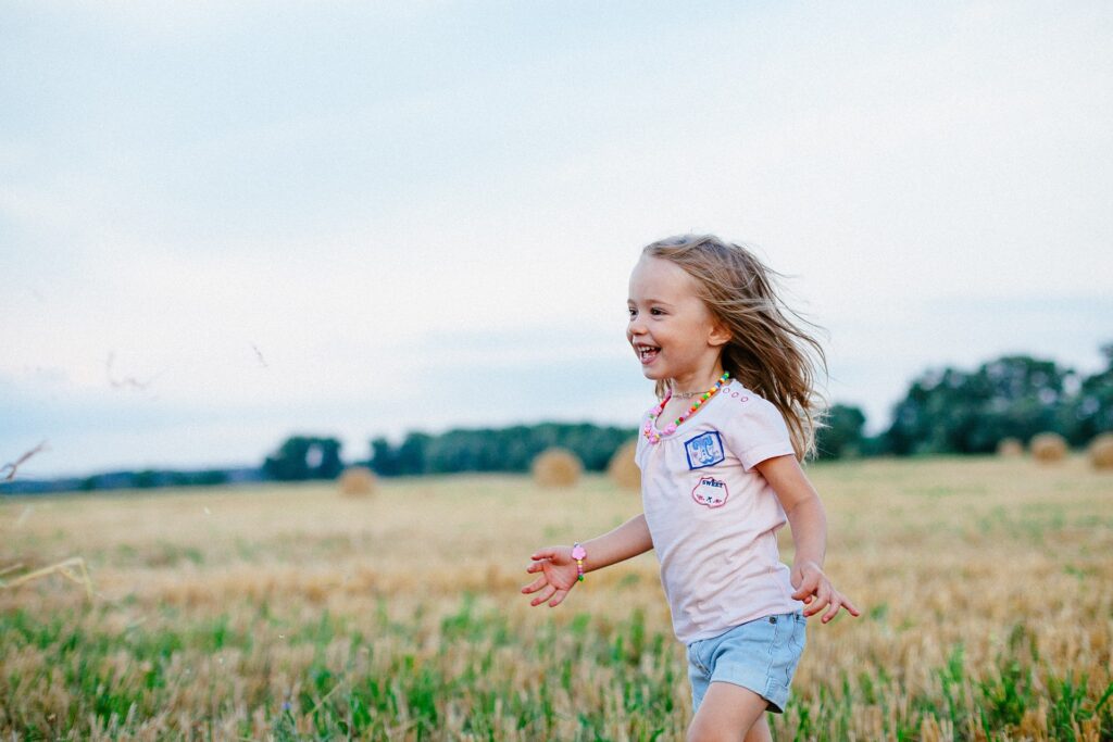 girl running through field