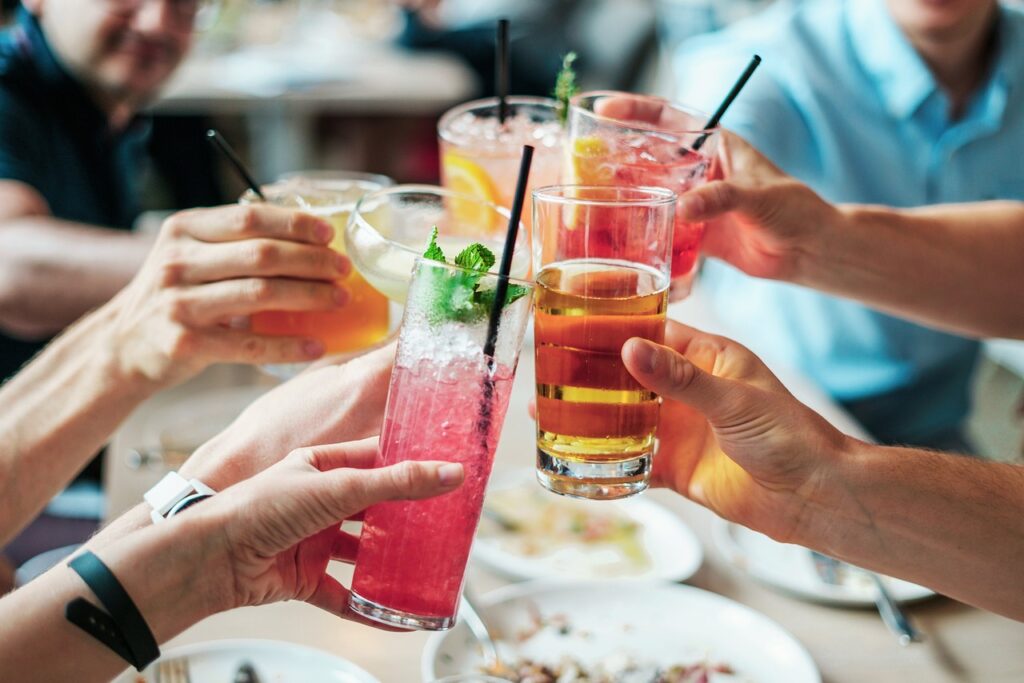 group of friends giving cheers with their alcohol drinks