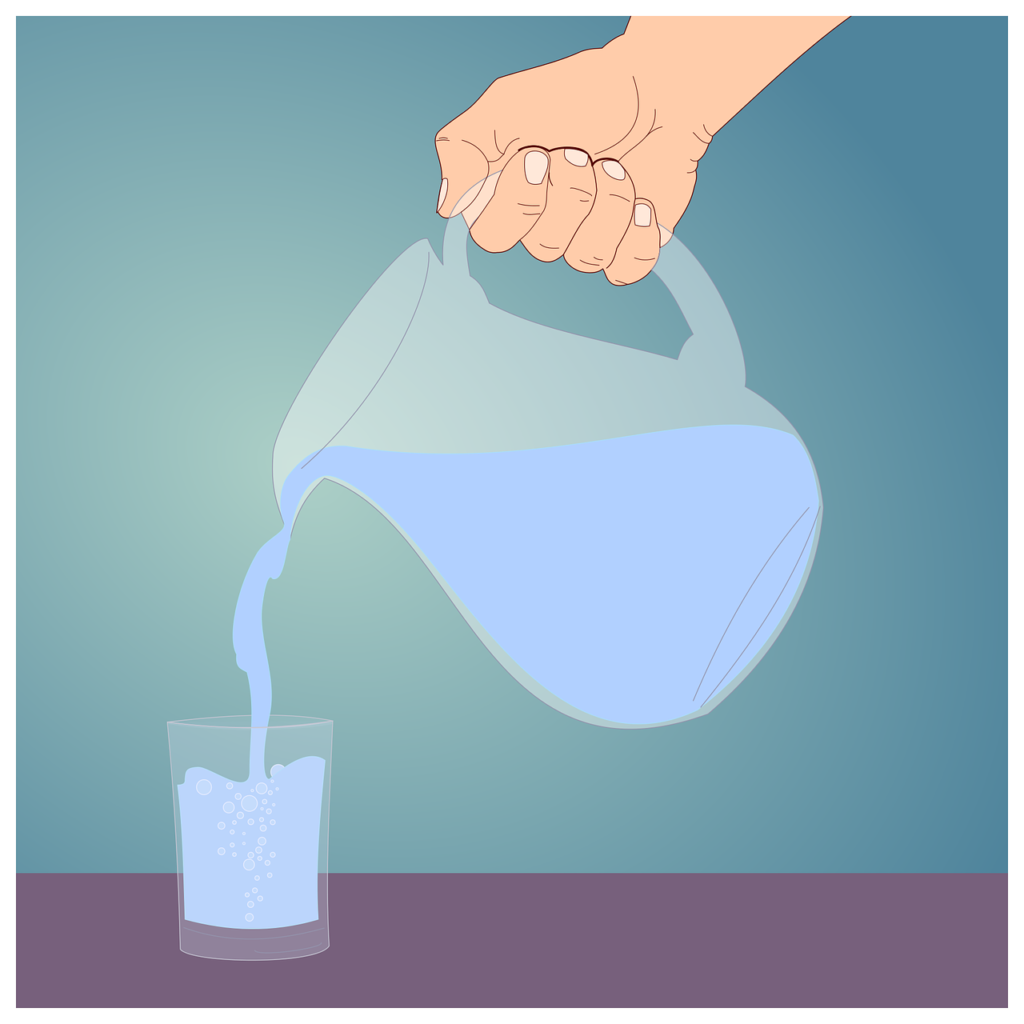 filling up a cup of water using a pitcher