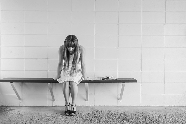 woman on bench feeling anxious