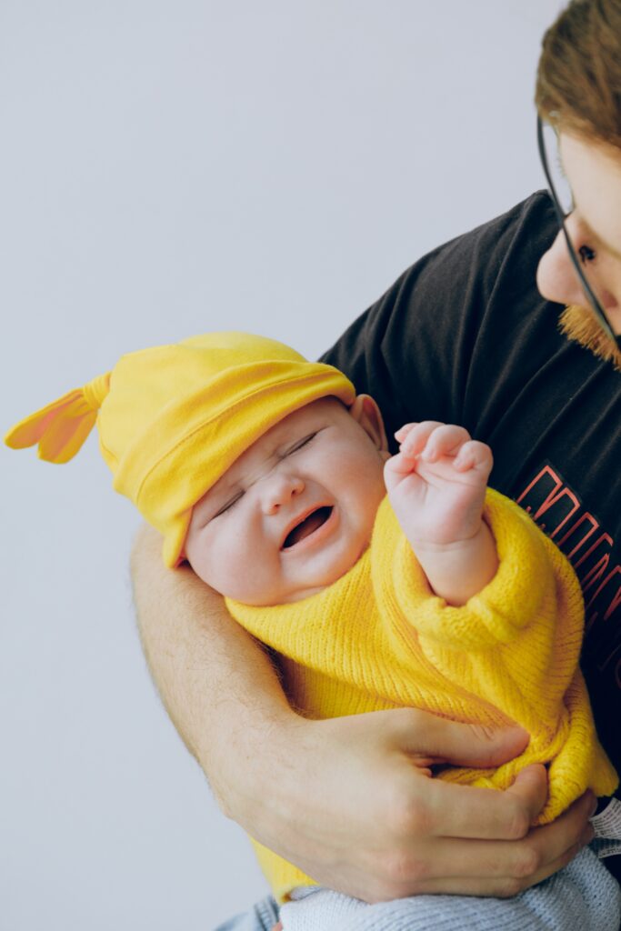 fussy baby held by dad